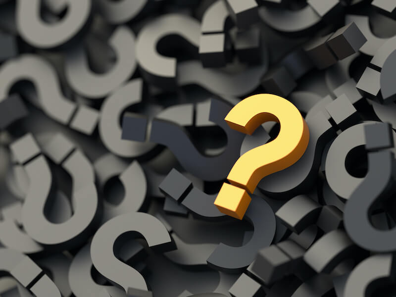 Yellow question mark on a background of black sign to reiterate the question; is there a cure for hearing loss.