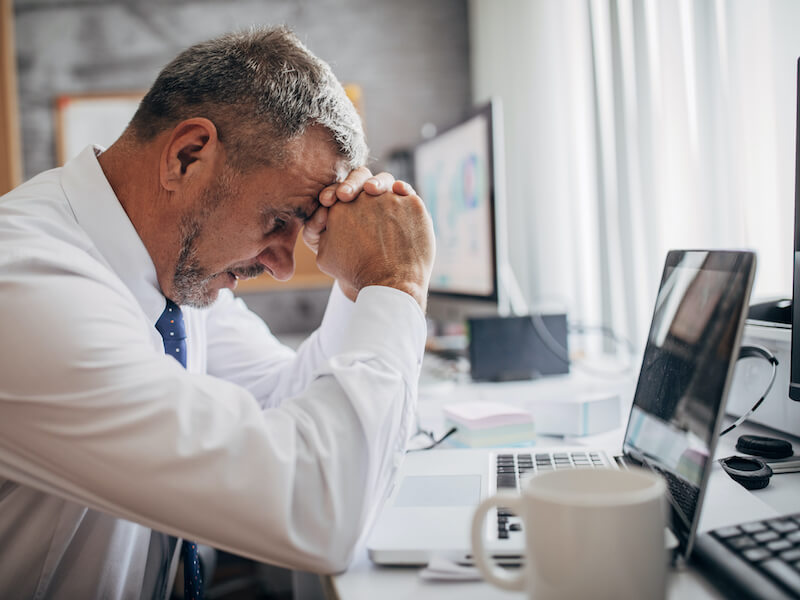 Businessman worried about his hearing los at work