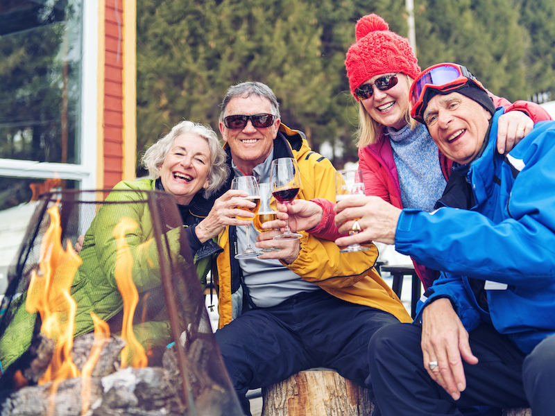 Senior friends wearing aids enjoying a day on the slopes 