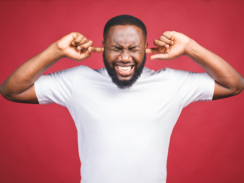 Man with constant ringing in his ears thinking about getting a hearing aid.