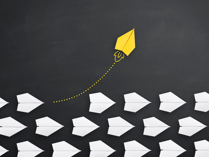 Group of paper plane in one direction and with one individual pointing in the different way, can be used leadership/individuality concepts. New idea, change, trend, courage, creative solution, innovation and unique way concept. Consider upgrading your hearing aids.