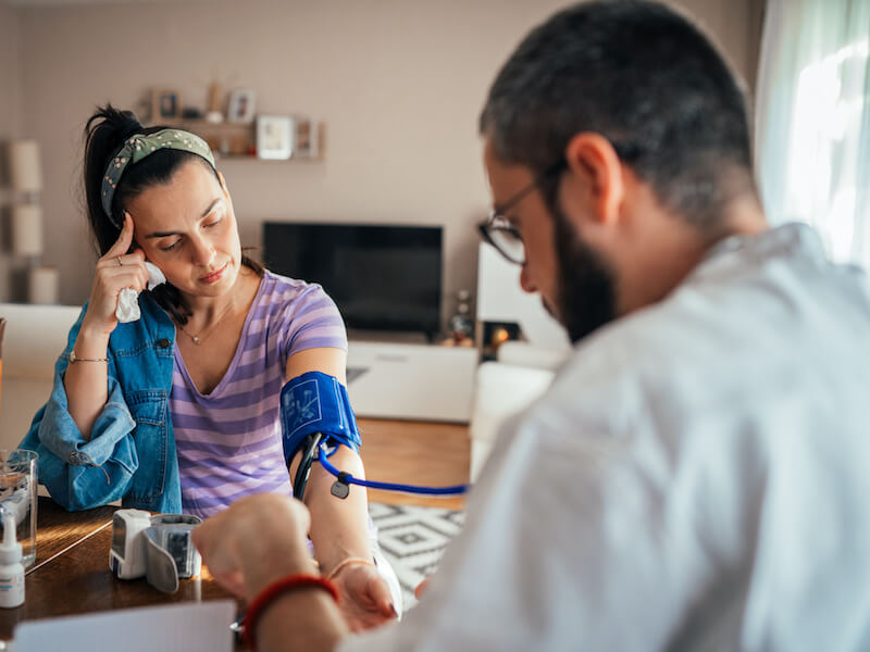 Pregnant woman who's suffering from sudden hearing loss having her blood pressure checked
