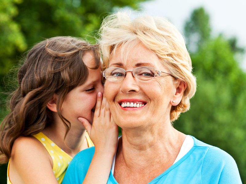 Woman recovers her hearing after an ear infection and listens to her grandaughter whisper something in her ear.